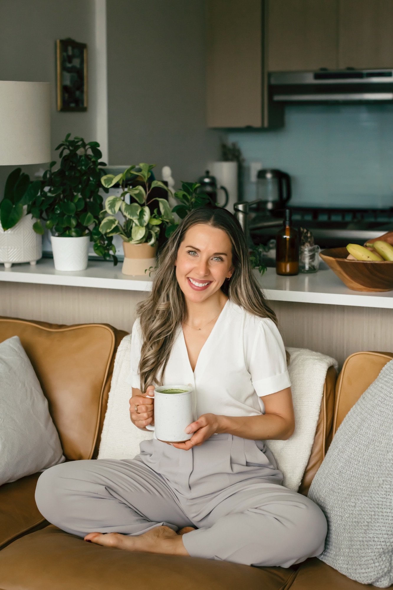 Lisa Podlecki, Registered Dietitian in Vancouver, seated with a matcha latte