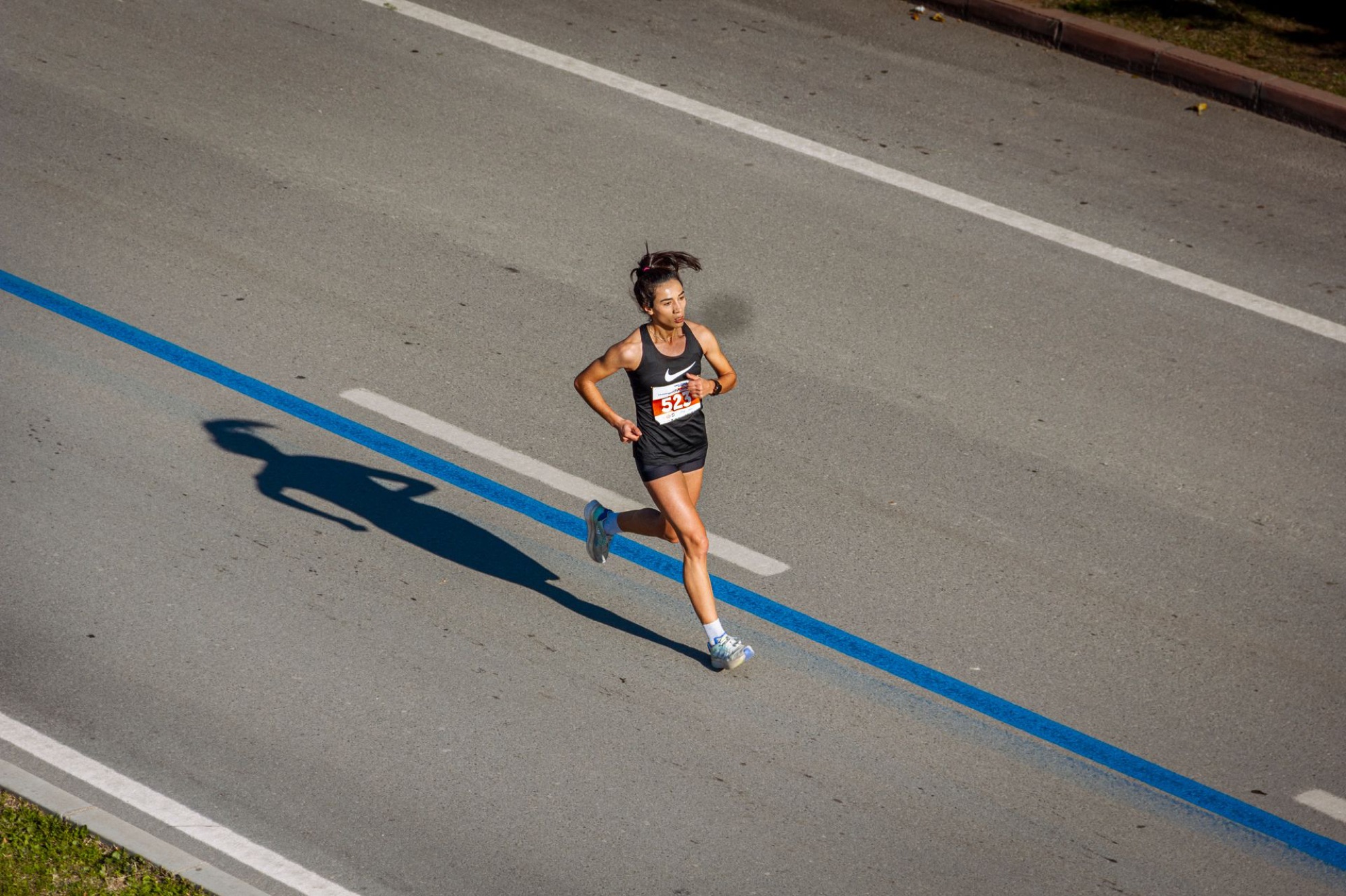 Woman running a road race — sports nutrition support for runners in Vancouver and BC