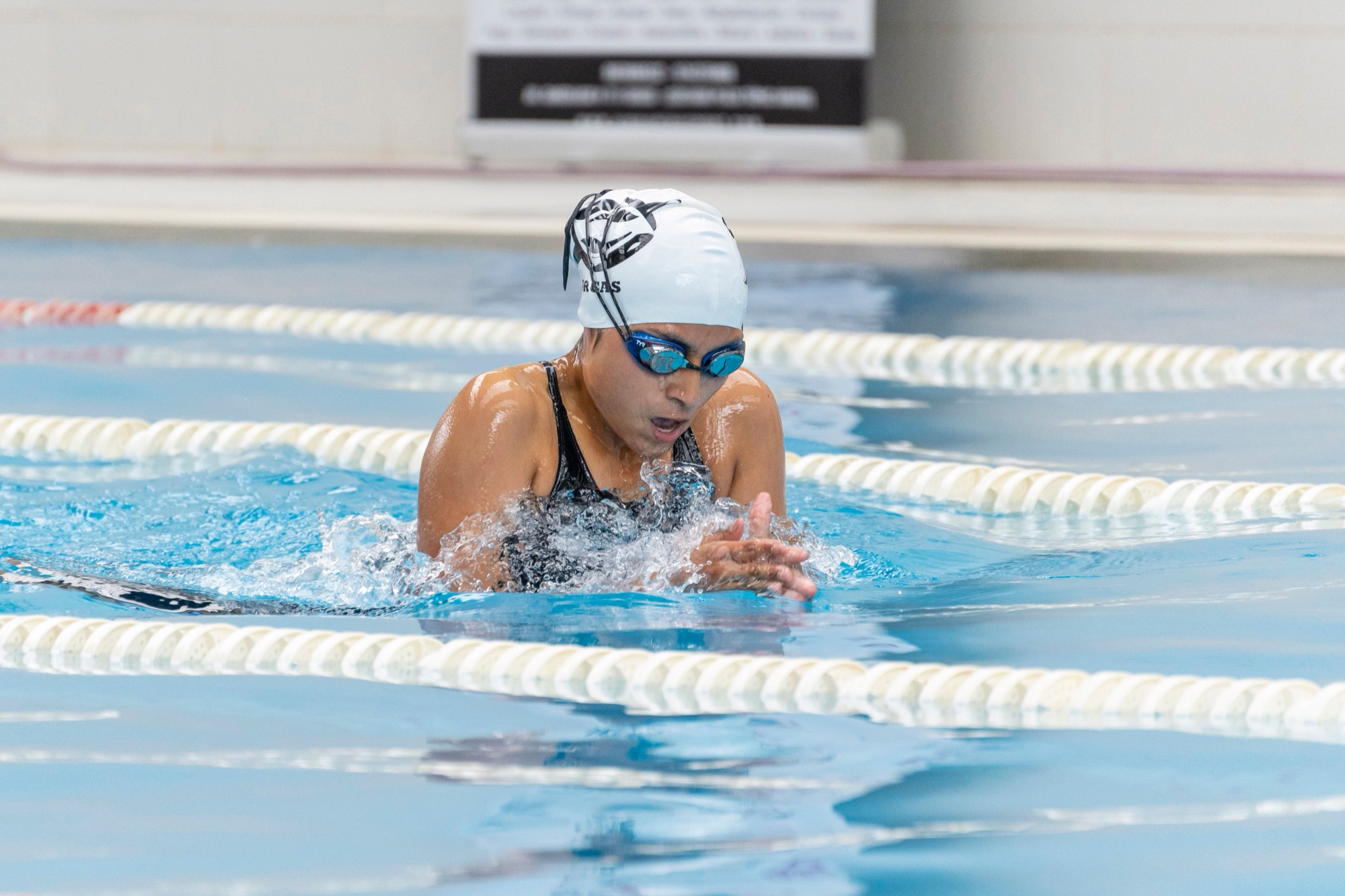 Woman swimming laps in a pool — nutrition support for swimmers