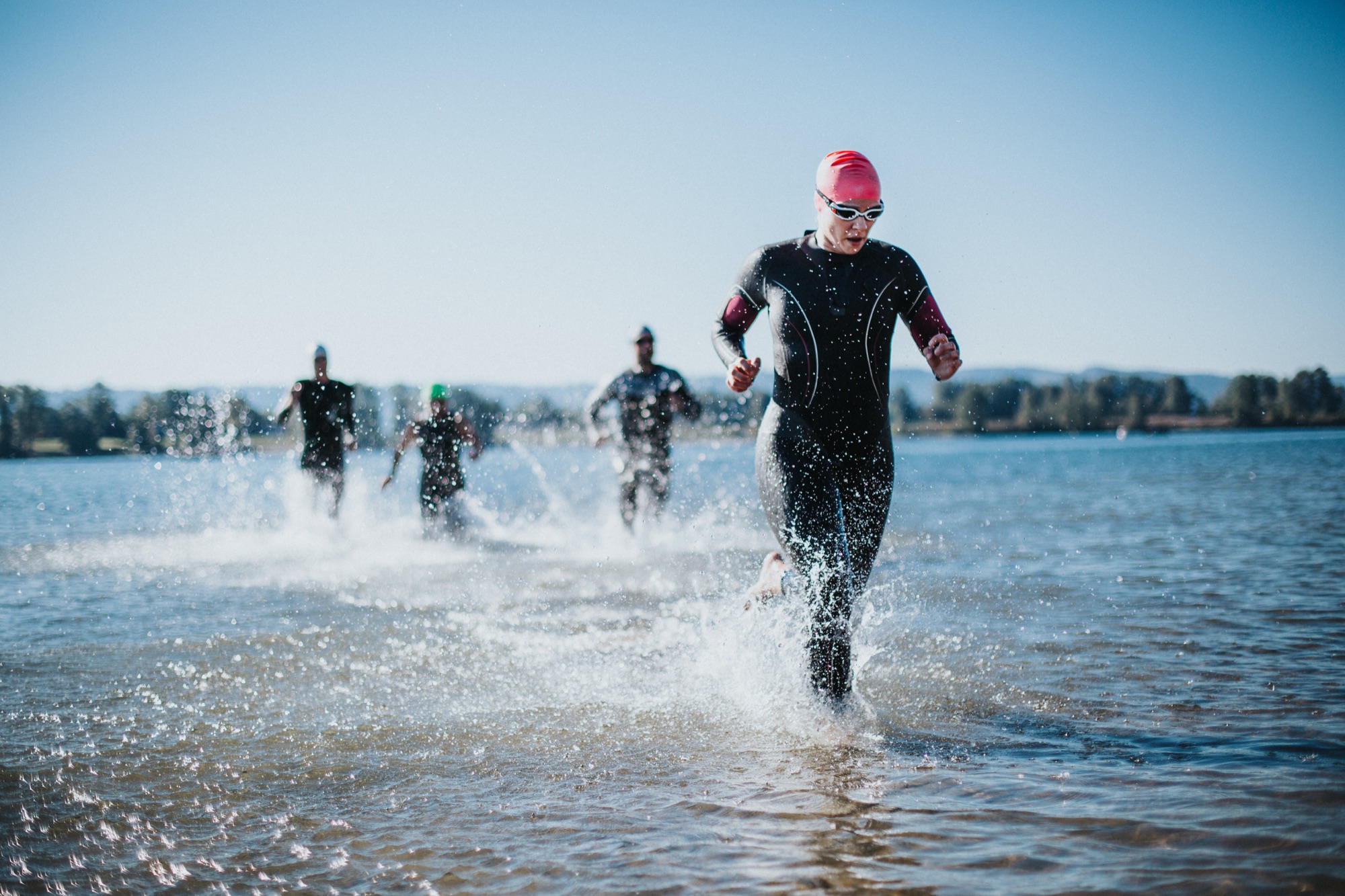 Woman finishing the open-water swim in a triathlon — sports nutrition for triathletes